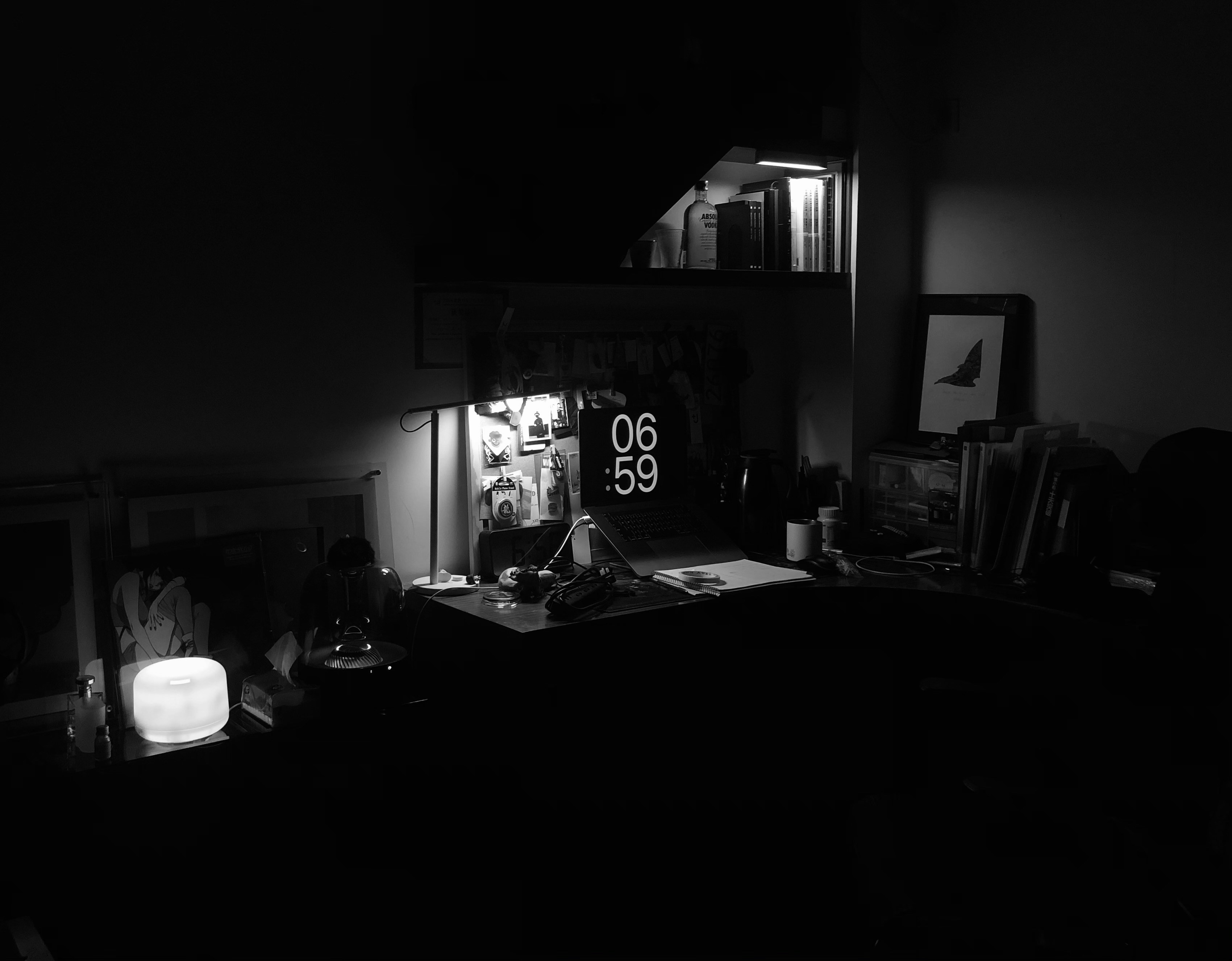 a dark room lit only by a screen at 06:59